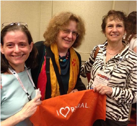 Attendees at the COF rural philanthropy gathering pose with a Love Rural bandanna. 